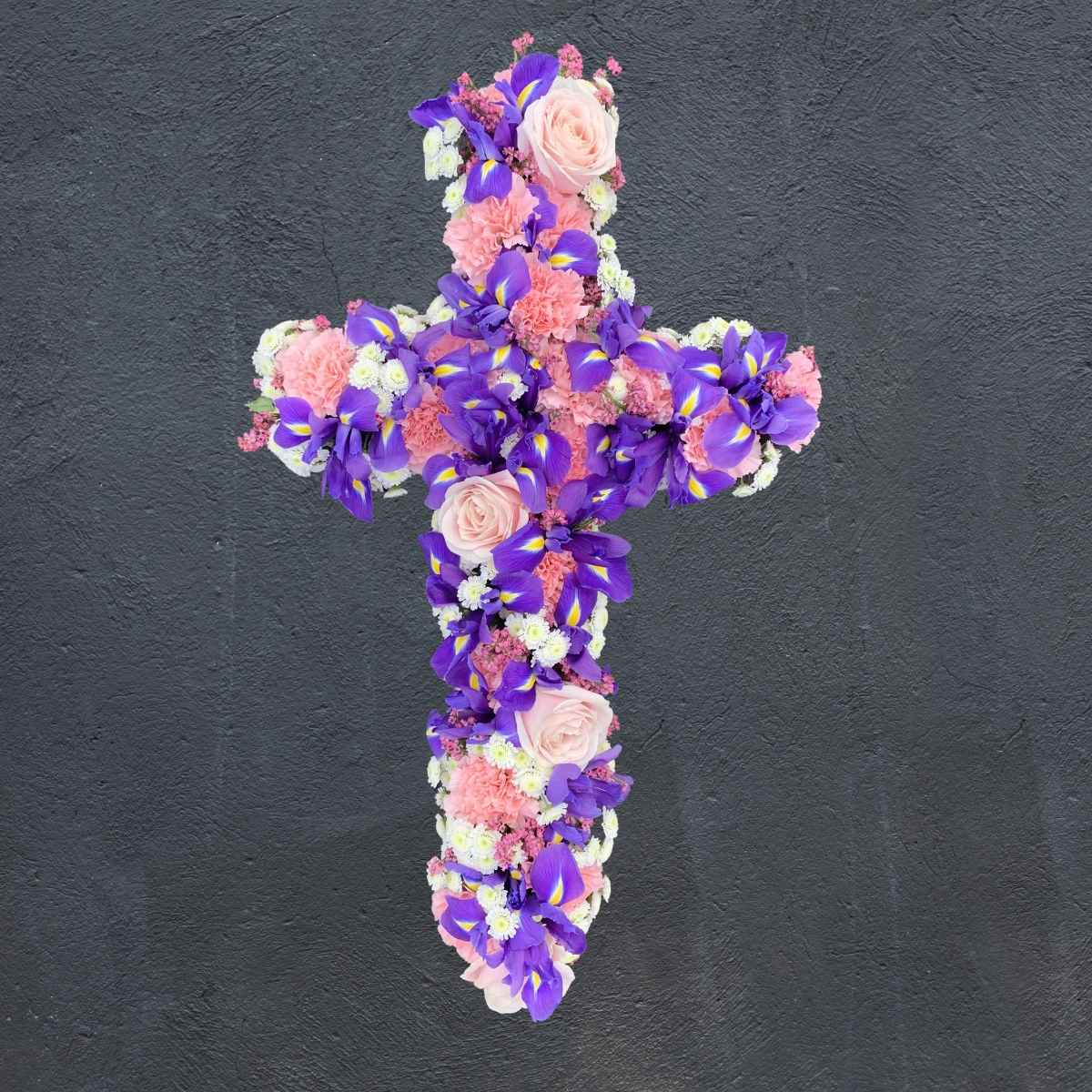 Pink and purple cross-shaped funeral tribute by Beloved Flowers, Kent