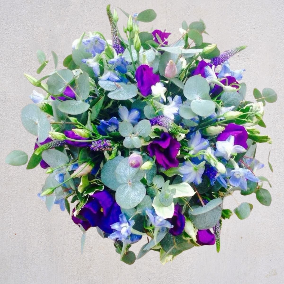 Purple, white and blue summer funeral posy by Beloved Flowers, Kent
