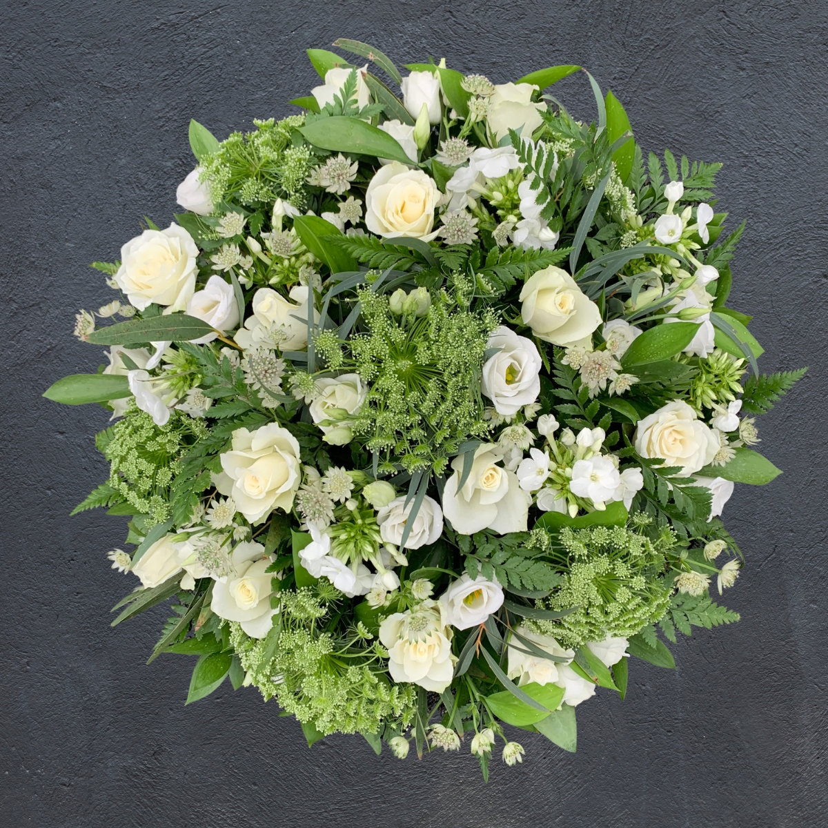 White and green rose and lisianthus funeral posy by Beloved Flowers, Kent